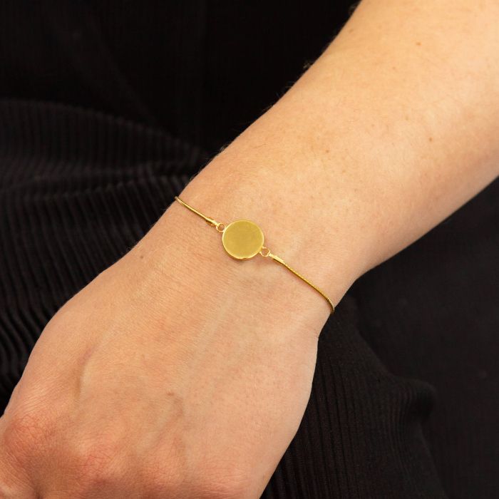 Engravable Gold Disc Toggle Bracelet worn on wrist