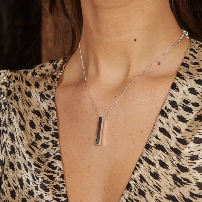woman wearing engraved silver bar necklace