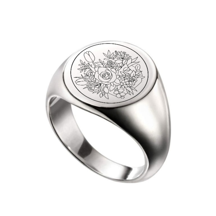 Silver ring with floral engraving on a white background