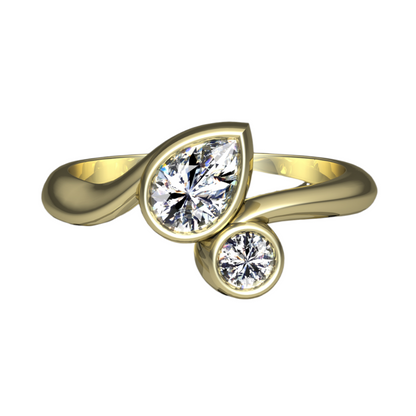 A top view of an organically shaped yellow gold ring set with a pear shape and brilliant cut diamond