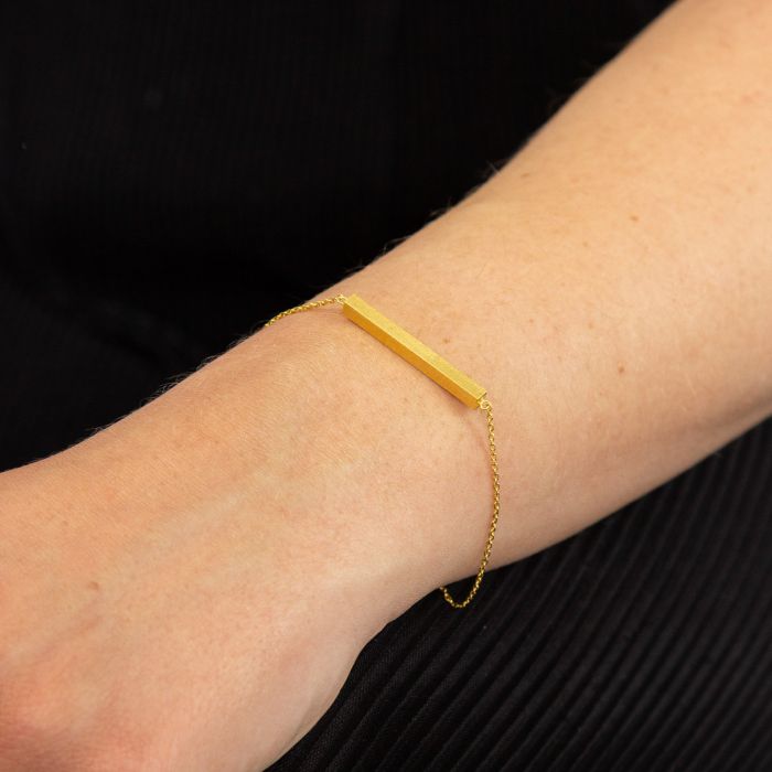 Gold Horizontal Bar Bracelet on wrist