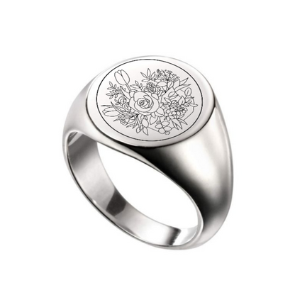 Silver ring with floral engraving on a white background